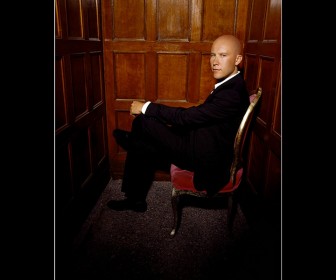 Lex Luthor On Chair Portrait Wallpaper